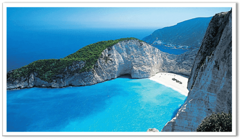 High angle view of Navagio Beach, also known as Shipwreck Bay, featuring white sands, turquoise waters, and limestone cliffs in Zakynthos.