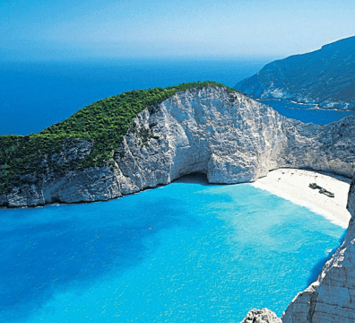 Panoramic view of the famous Shipwreck Beach in Zakynthos with turquoise water and limestone cliffs.