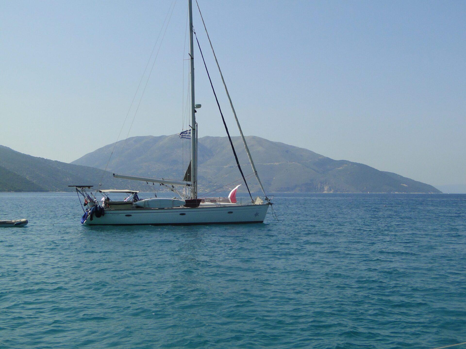 A stunning aerial view of a luxury yacht at anchor in the Greek Ionian, perfect for a bareboat charter greece sailing holiday.