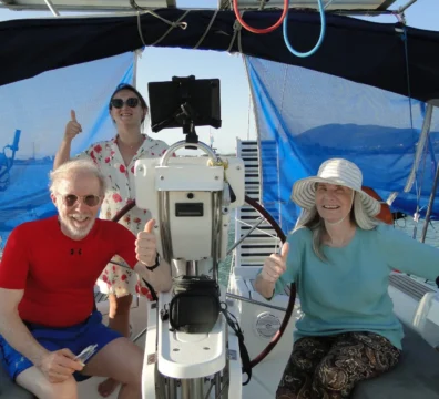 Guests enjoying the deck of a sailing yacht in Greece at sunset 2026