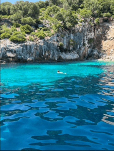 Crystal clear turquoise swimming bay in Fiskardo, Kefalonia, a top destination on our Greek sailing holidays.