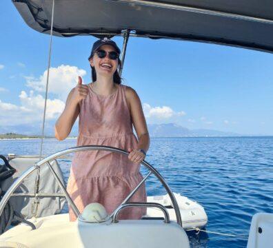 A happy passenger enjoying a luxury sailing holiday in the Ionian with a private skipper, 2026 season