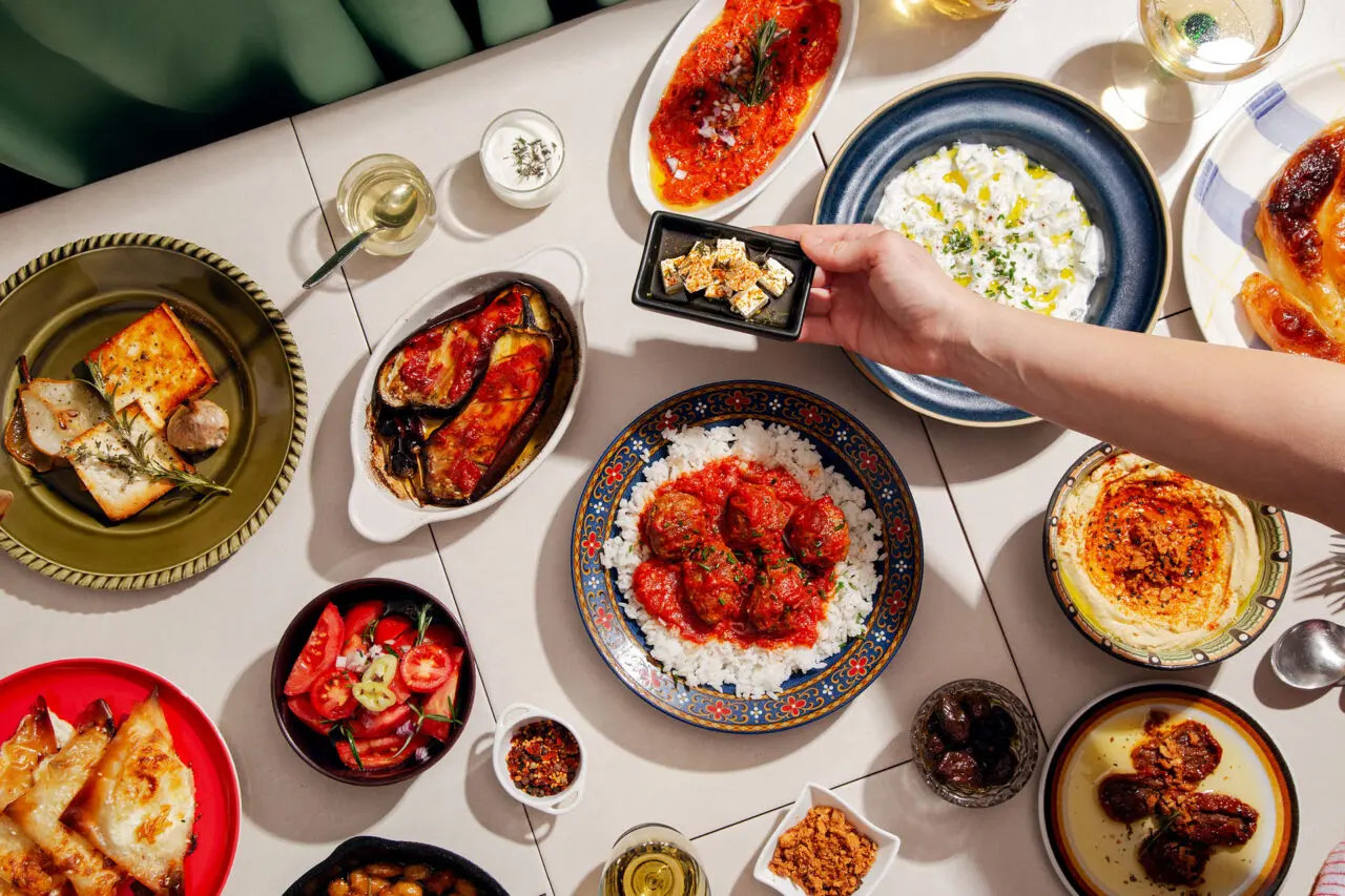 A table spread of fresh Mediterranean dishes served on the deck of a sailing yacht
