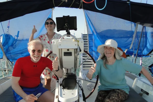 Guests enjoying the deck of a sailing yacht in Greece at sunset 2026